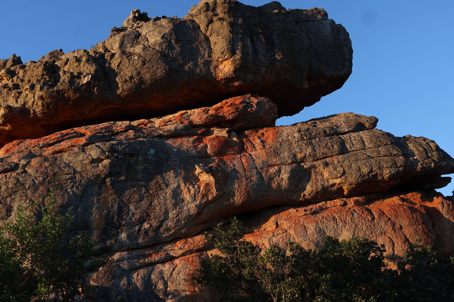 Stacked sandstone slabs in the Cederberg above Citrusdal, lit orange at golden hour