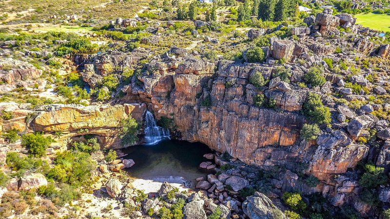 An aerial view of a rock pool below a waterfall on a farm near Citrusdal.