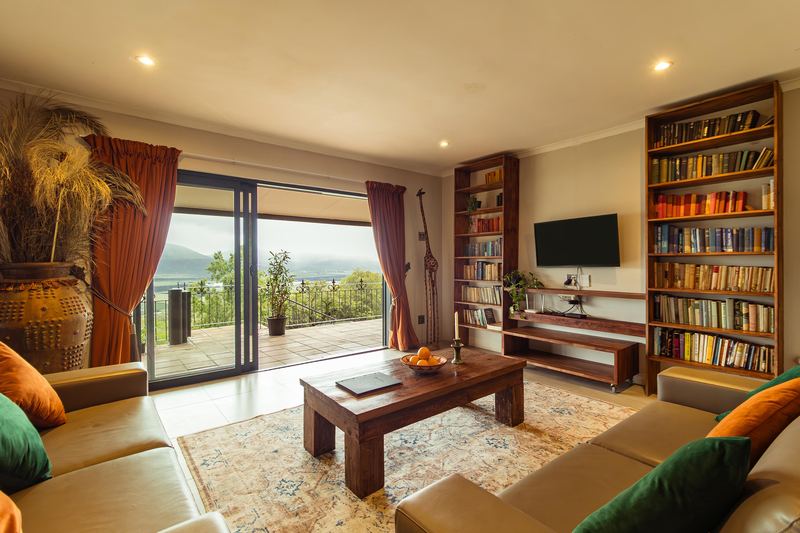 The lounge at Kokerboom house, bookshelves on both sides and sliding doors to the stoep.